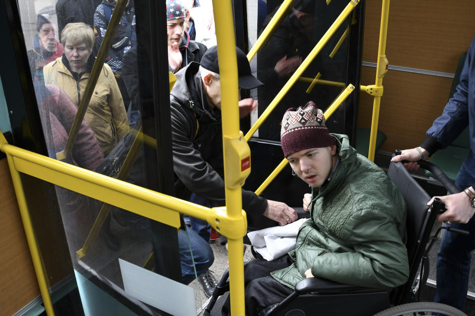 People board transportation during evacuation of civilians in Kramatorsk, Ukraine, Sunday, April 10, 2022. (AP Photo/Andriy Andriyenko)