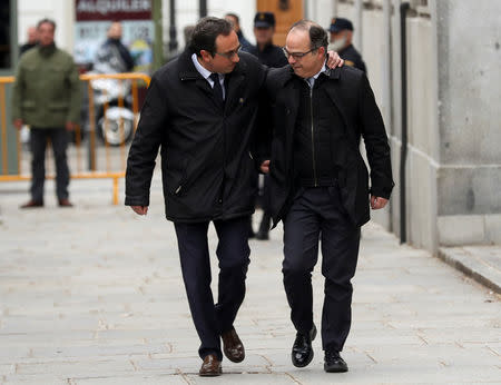 FILE PHOTO: Catalan politicians Josep Rull (L) and Jordi Turull arrive together to the Supreme Court after being summoned and facing investigation for their part in Catalonia's bid for independence in Madrid, Spain, March 23, 2018. REUTERS/Susana Vera