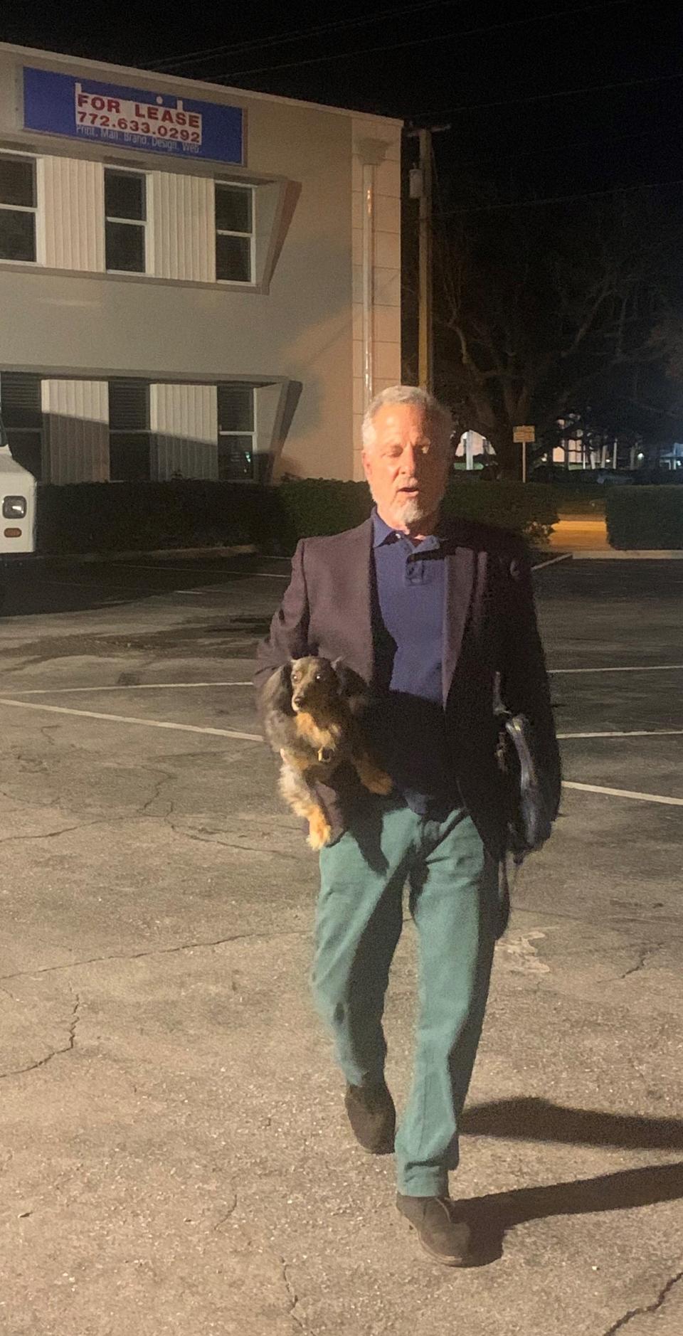 Andres Duany, an urban planner hired to draw a master plan for Vero Beach's downtown, walks toward 21st Amendment Distillery Feb. 5, 2024, with his dog, Bailey. Duany had just discussed the proposed master plan with about 180 people at the Heritage Center.