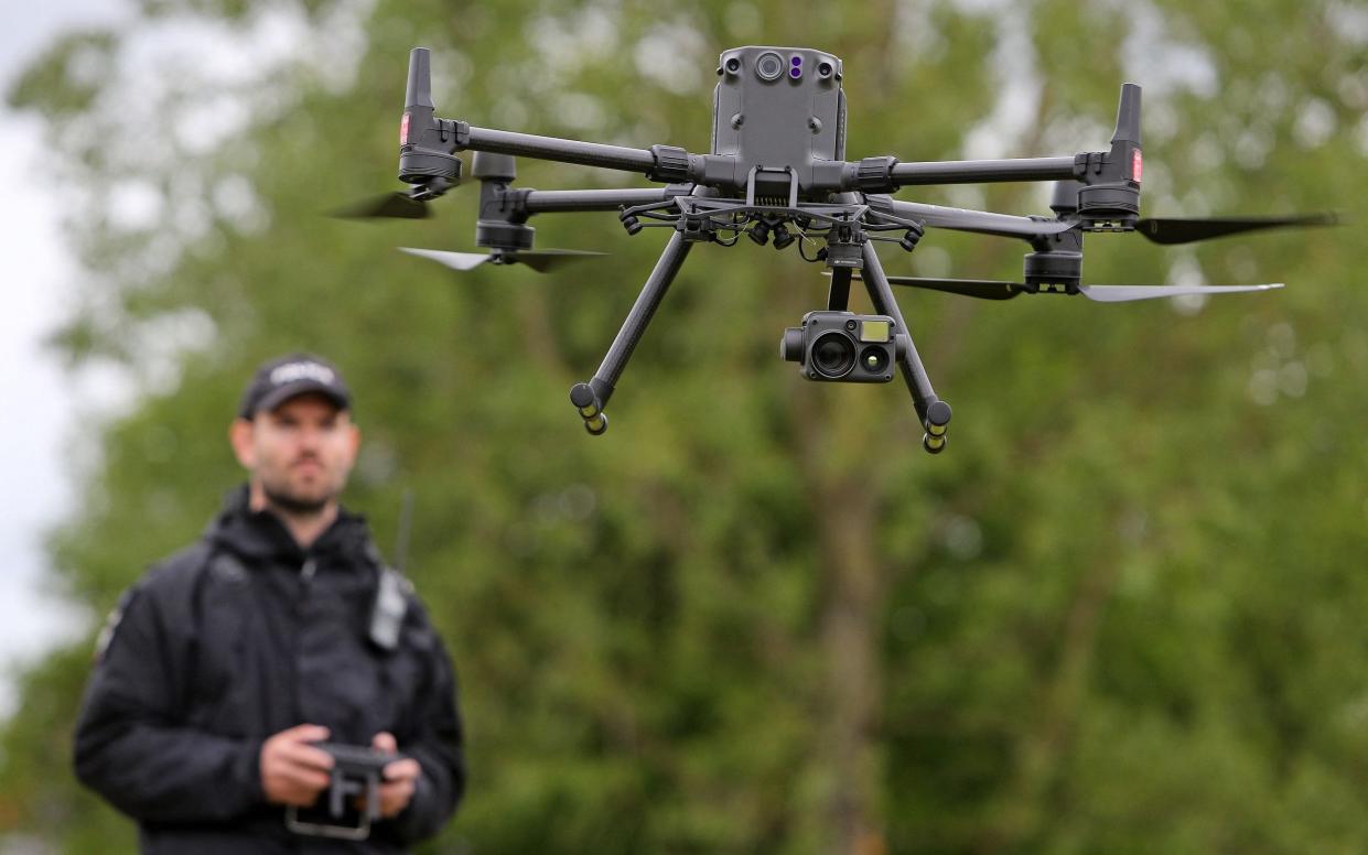 A police officer demonstrates a drone in flight