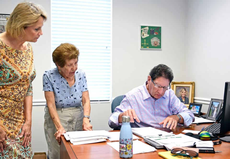 Diana Grandy, a ERAP Specialist, Sarasota County's Emergency Rental Assistance program, helps out  89-year-old Edith Marcus, in middle, with Phil Heller the housing navigator with Gulfcoast Legal Services working on her case. Edith was called by a leasing consultant at The Reserve at Palmer Ranch Apartments in Sarasota who informed her that her signed-for apartment would no longer be held for her — 72 hours before she was set to move in.
