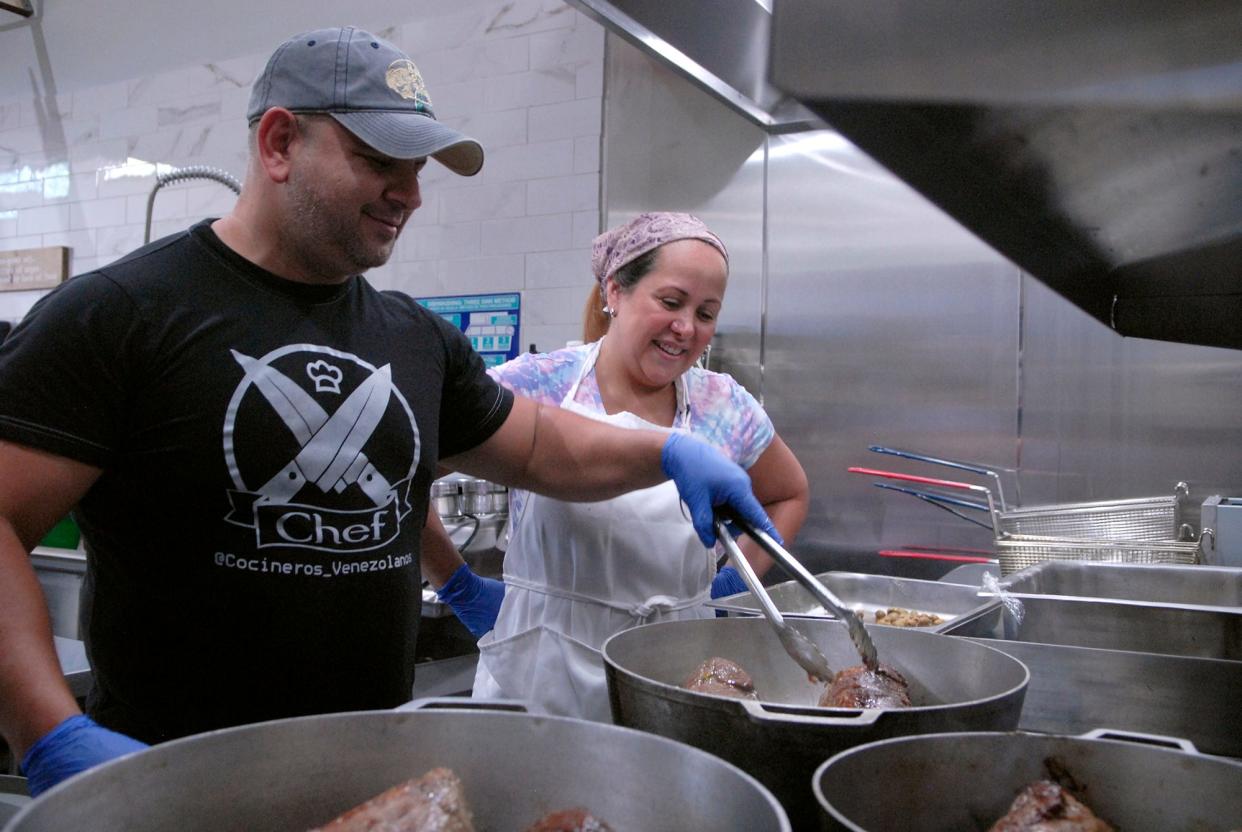 Nelson Michelangeli cooks beef for a Venezuelan dish at Alchemy Kitchen while his wife, Nahyla watches. Oct. 02, 2019