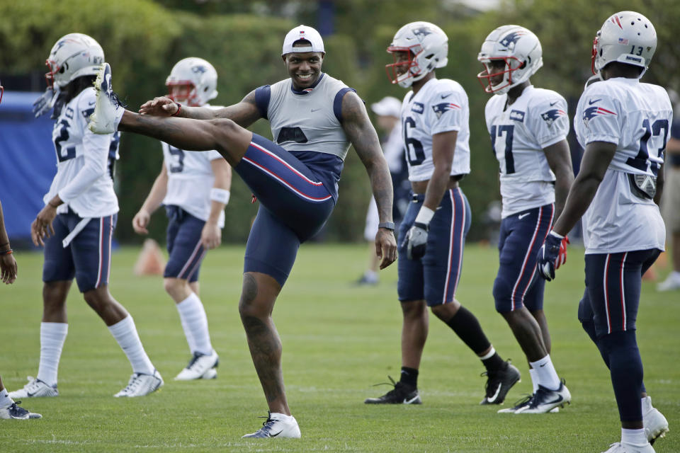 New England Patriots wide receiver Josh Gordon, third from left, warms up with teammates at NFL football practice, Monday, Aug. 19, 2019, in Foxborough, Mass. (AP Photo/Elise Amendola)