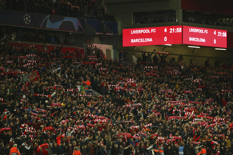 FILE - In this May 7, 2019, file photo, Liverpool supporters celebrate after winning the Champions League semifinal, second leg, soccer match 4-0 against FC Barcelona at the Anfield stadium in Liverpool, England. (AP Photo/Dave Thompson, File)
