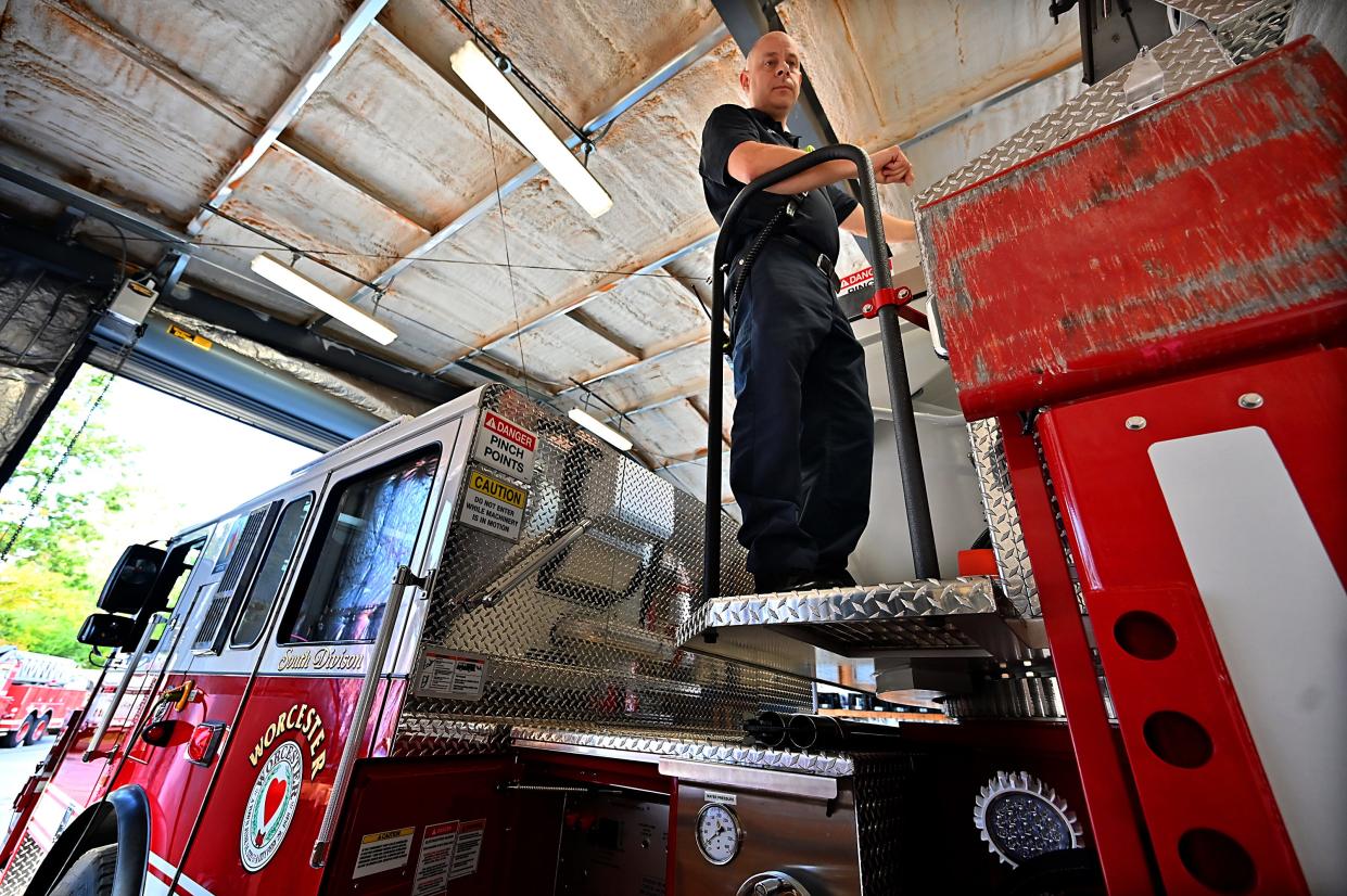 Capt. Matthew Santon stands atop the Worcester Fire Department's new 95-foot Seagrave tower ladder truck.