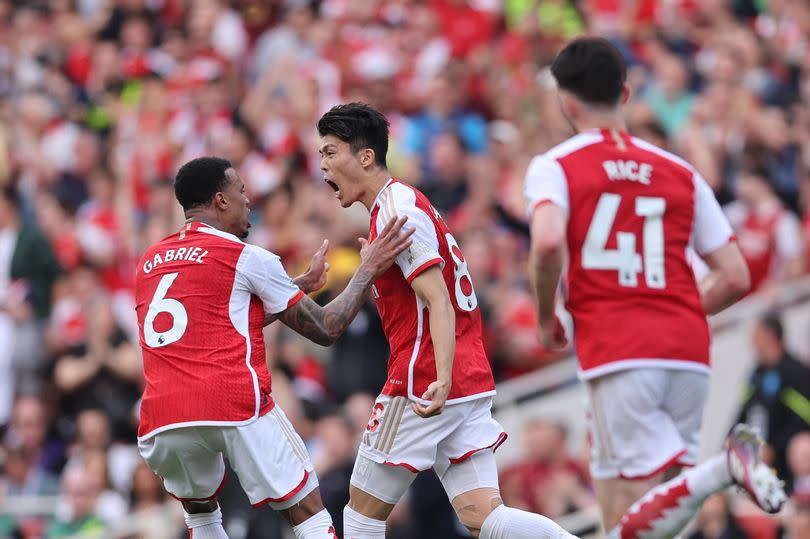 Arsenal players celebrate a goal against Everton