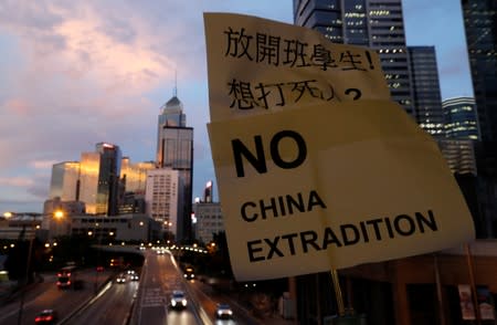 A placard is displayed during a protest following a day of violence over a proposed extradition bill, near the Legislative Council building in Hong Kong