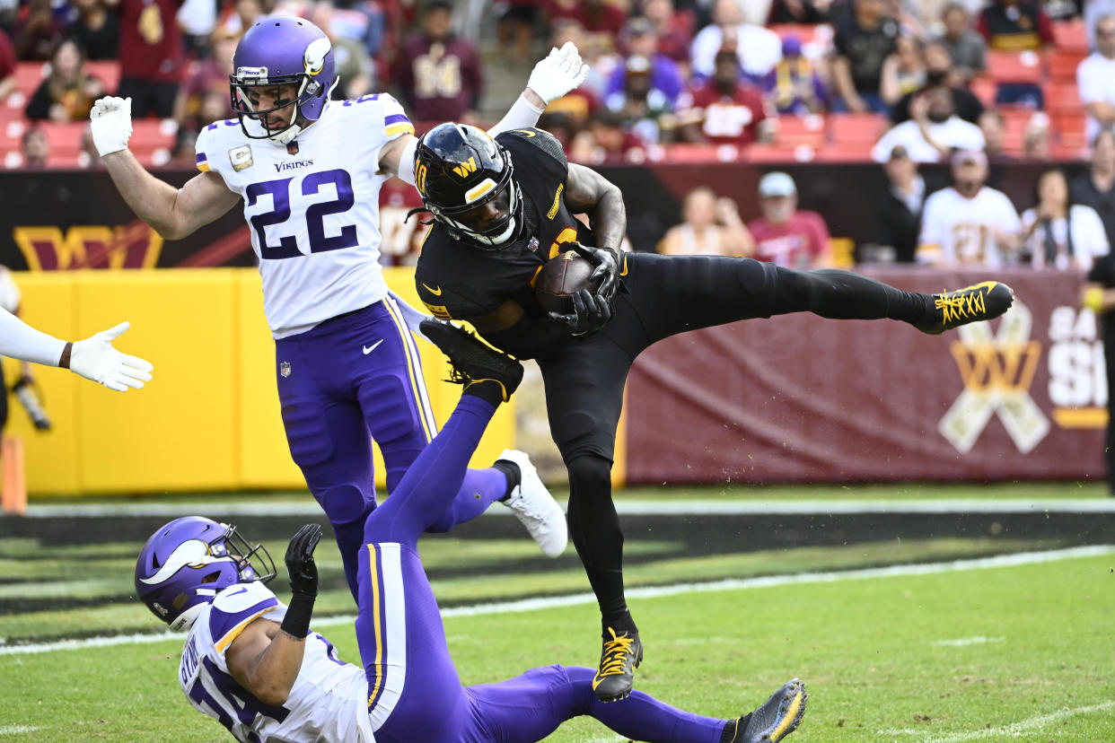 Nov 6, 2022; Landover, Maryland, USA; Washington Commanders wide receiver Curtis Samuel (10) makes a touchdown  reception between Minnesota Vikings safety Harrison Smith (22) and safety Camryn Bynum (24) during the second half at FedExField. Mandatory Credit: Brad Mills-USA TODAY Sports