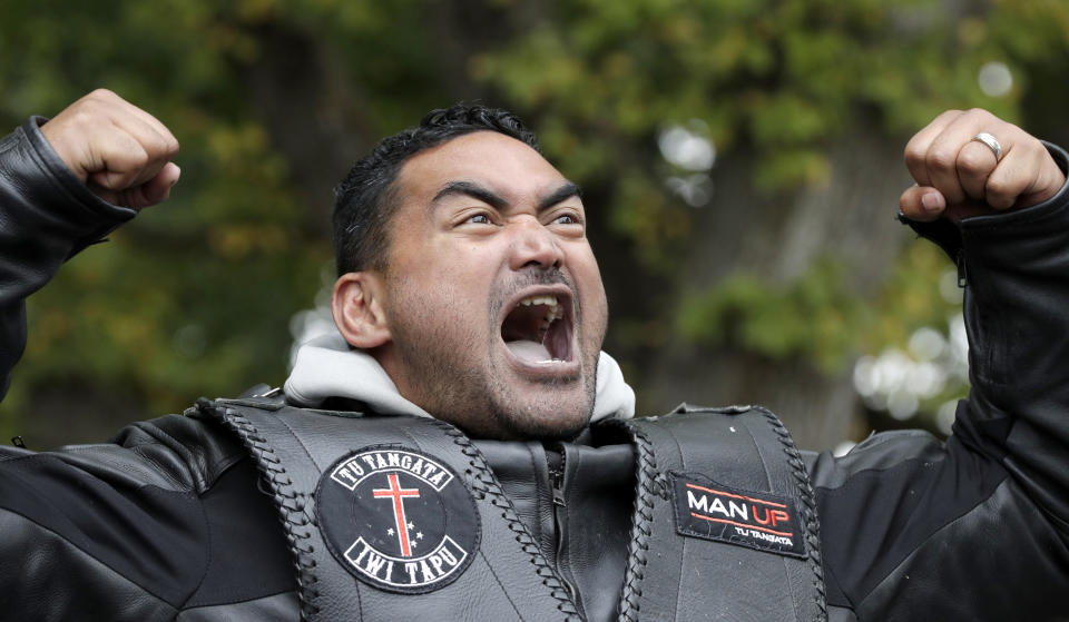 A members of the Tu Tangata motorcycle club reacts as he performs a haka outside the Al Noor mosque in Christchurch, New Zealand, Sunday, March 15, 2020. A national memorial in New Zealand to commemorate the 51 people who were killed when a gunman attacked two mosques one year ago has been canceled due to fears over the new coronavirus. (AP Photo/Mark Baker)