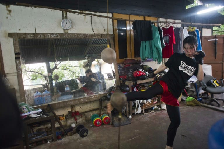 A young woman practicing Myanmar's homespun martial art Lethwei -- a sport that encourages head-butting and grants victory by knock-out only -- at a gym in Yangon