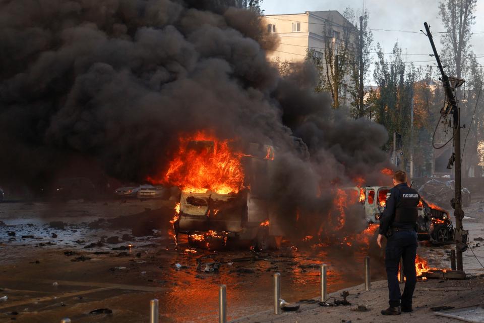 Cars are seen on fire after Russian missile strikes (REUTERS)