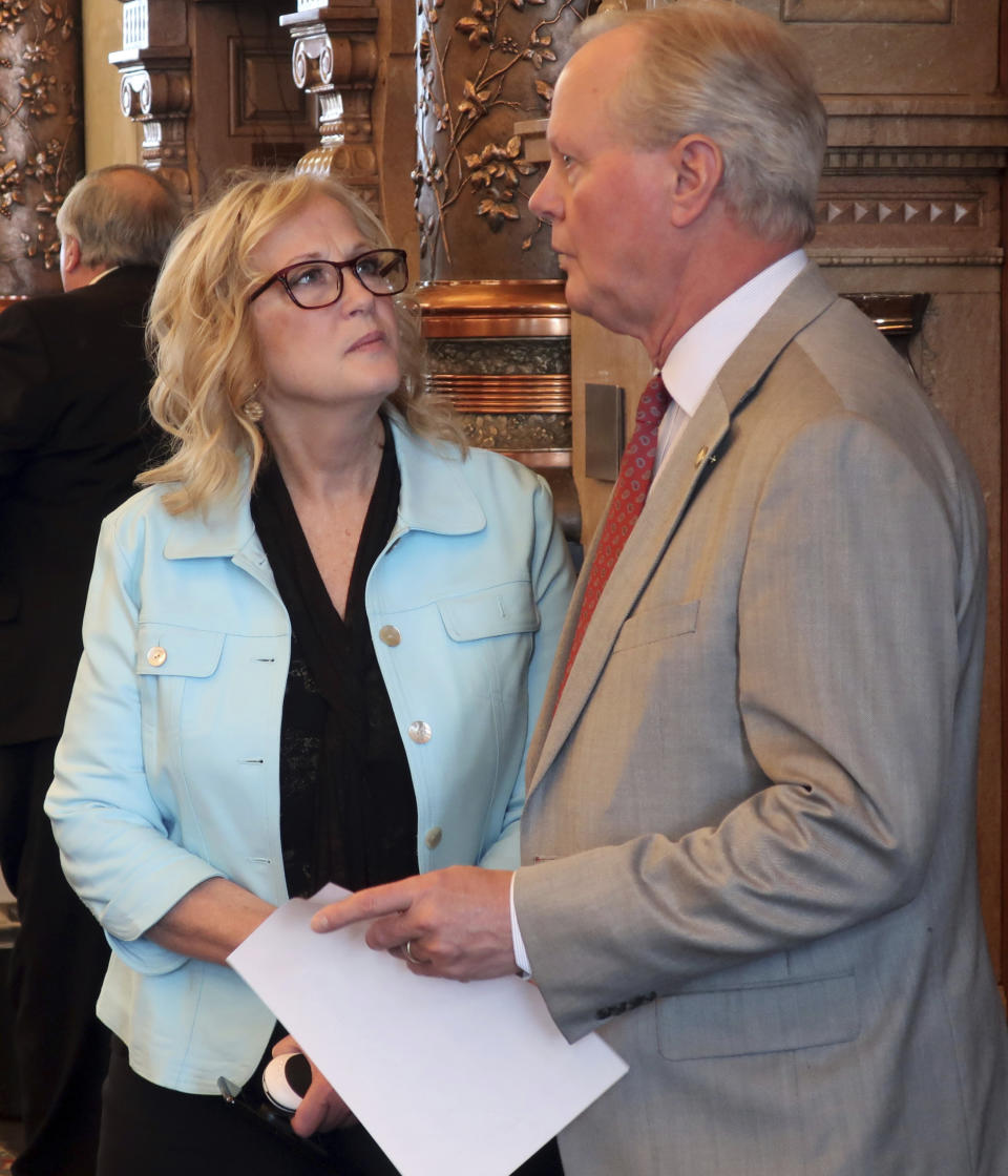 In this Wednesday, Feb. 13, 2019 photo, Kansas state Sen. Mary Pilcher-Cook, left, R-Shawnee, confers with Sen. Gene Suellentrop, R-Wichta, before a Senate debate on a resolution condemning New York's new abortion law, at the Statehouse in Topeka, Kansas. Pilcher-Cook says Kansans lawmakers ought to make their opposition known because New York's law is "a civil rights issue." (AP Photo/John Hanna)