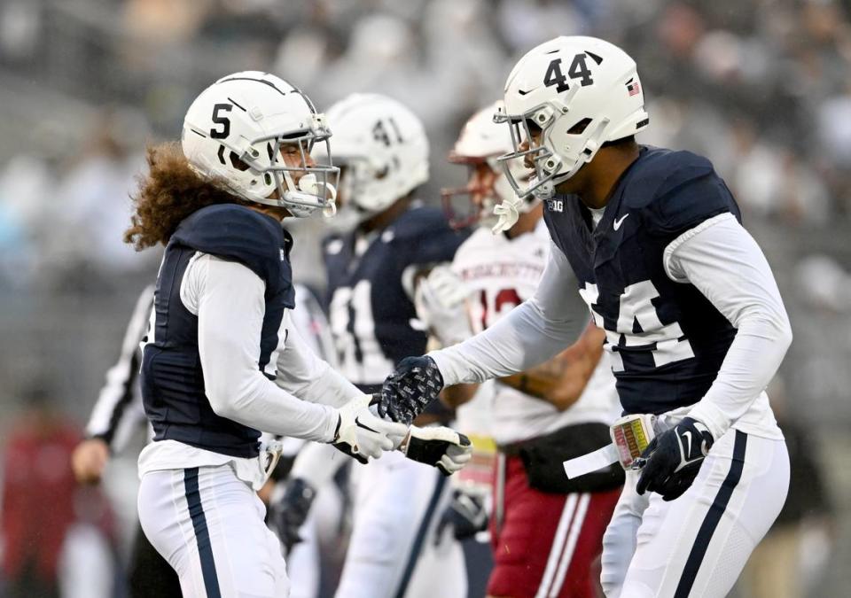 Penn State cornerback Cam Miller celebrates his sack with Chop Robinson during the game against UMass on Saturday, Oct. 14, 2023.