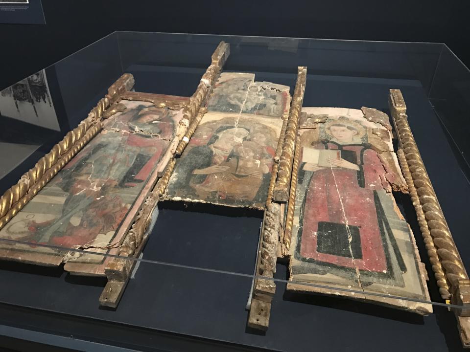 In this photo taken on Friday, March 31, 2017, a triptych saved from the San Vittorino church in Castelsantangelo sul Nera, central Italy, is displayed at the Uffizi Gallery in Florence, Italy. The Uffizi Gallery is showing solidarity with the art-rich, quake-stricken Marche region with an exhibit of treasures saved from a series of earthquakes last year. (AP Photo/Colleen Barry)