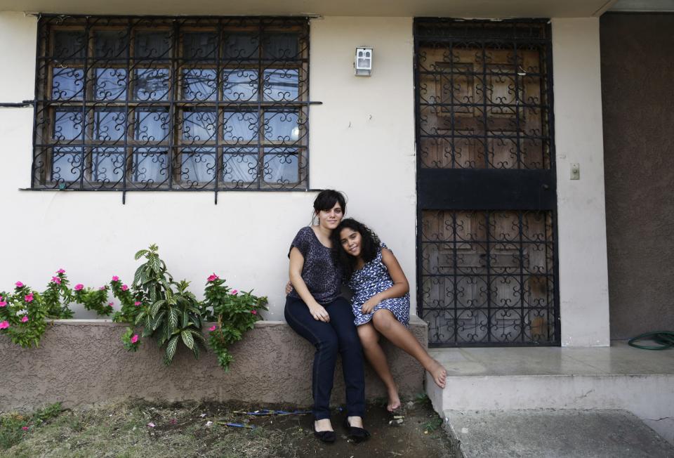 Marisa del Carmen and her daughter Alicia Isabel pose for a photograph outside their home in Panama City