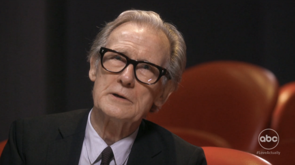 Billy Nighy talking in a theatre