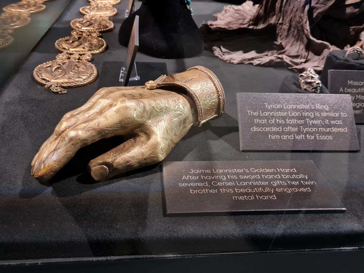 prop of jaime lannister's golden hand in a case at the game of thrones studio tour