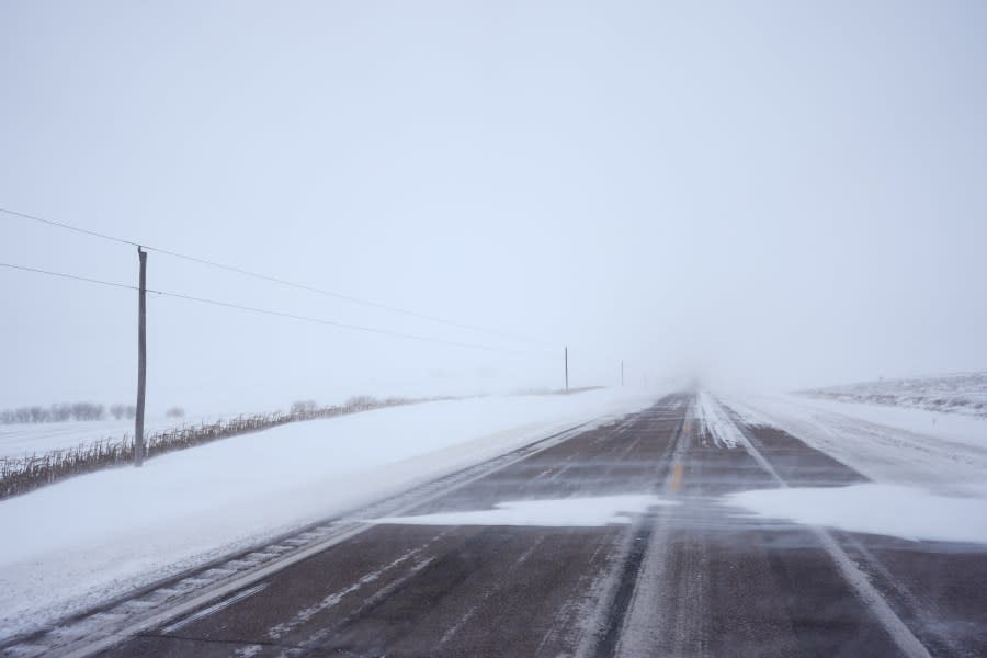 Snow blows over Iowa State Highway 3, near Le Mars, Iowa, Friday, Jan. 12, 2024. (AP Photo/Carolyn Kaster)