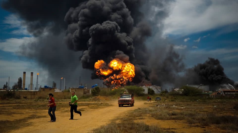 Fuel storage tanks burn after a vapor cloud explosion at the Amuay refinery in Punto Fijo, Venezuela, on August 27, 2012. - Meridith Kohut/The New York Times/Redux