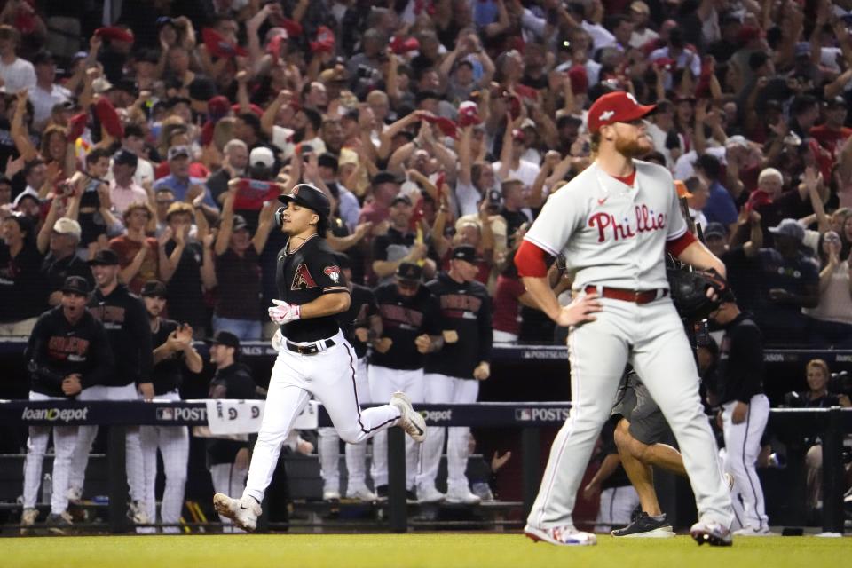 Arizona Diamondbacks center fielder Alek Thomas (5) rounds the bases after hitting a two-run home run during the eighth inning as Philadelphia Phillies relief pitcher Craig Kimbrel (right) looks on in Game 4 of the NLCS of the 2023 MLB playoffs at Chase Field in Phoenix on Oct. 20, 2023.