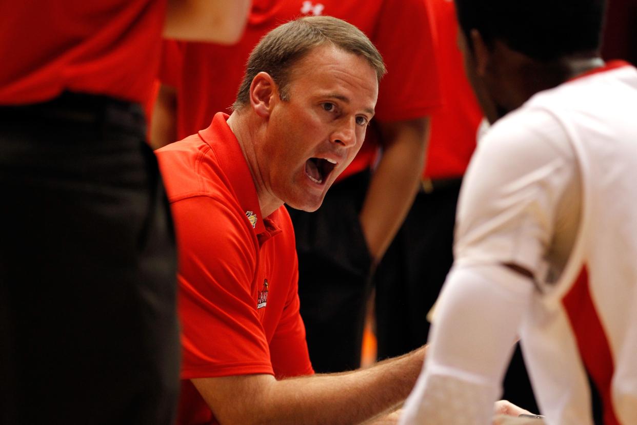 Coach Pat Knight of the Lamar Cardinals talks with his players during a first half timeout against the Vermont Catamounts in the first round of the 2012 NCAA men's basketball tournament at UD Arena on March 14, 2012 in Dayton, Ohio.