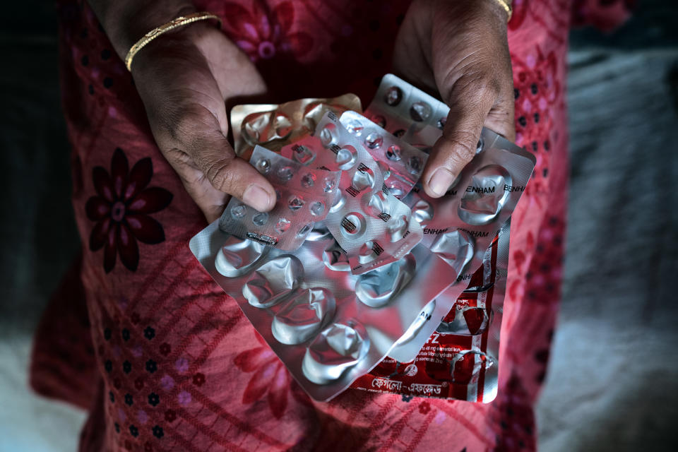Asma Akhter holds medications she needs for uterus infections and excessive bleeding after her operation. (Fabeha Monir for NBC News)