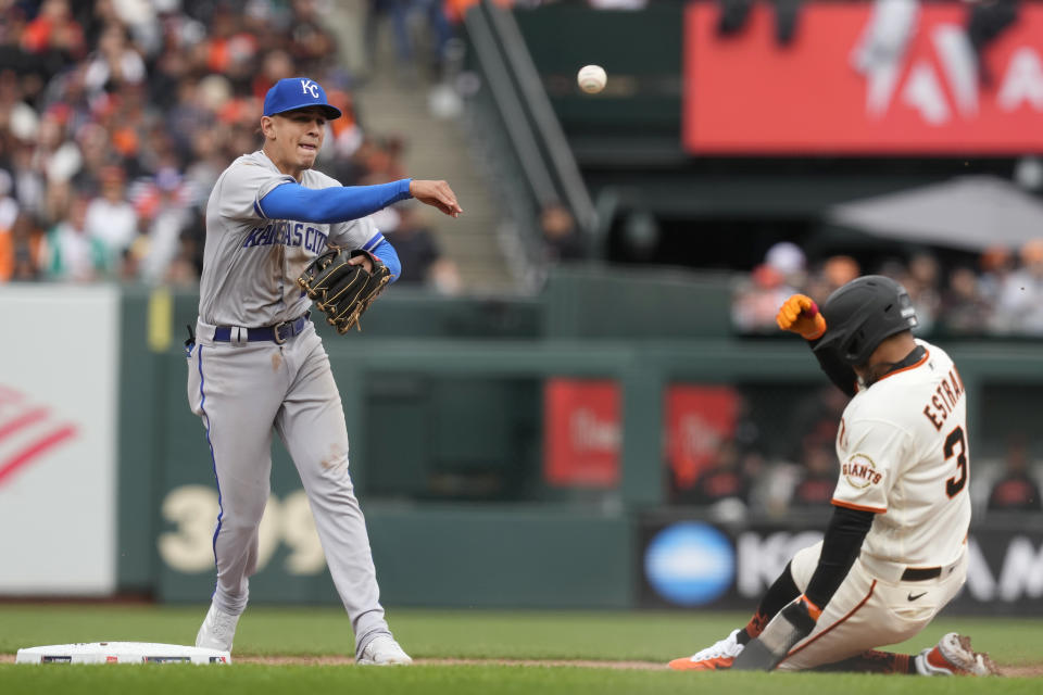 Kansas City Royals shortstop Nicky Lopez, left, throws to first base after forcing San Francisco Giants' Thairo Estrada out at second base on a double play hit into by Brandon Crawford during the fourth inning of a baseball game in San Francisco, Friday, April 7, 2023. (AP Photo/Eric Risberg)