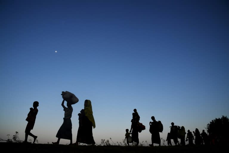 Rohingya Muslims from Myanmar walk towards refugee camps after entering Bangladesh by boat -- some of the more than 600,000 people to have fled persecution there