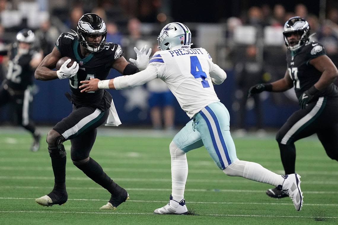 Philadelphia Eagles’ Josh Sweat intercepts a pass by Dallas Cowboys’ Dak Prescott and returns it for a touchdown during the first half of an NFL football game Saturday, Dec. 24, 2022, in Arlington, Texas. (AP Photo/Tony Gutierrez)