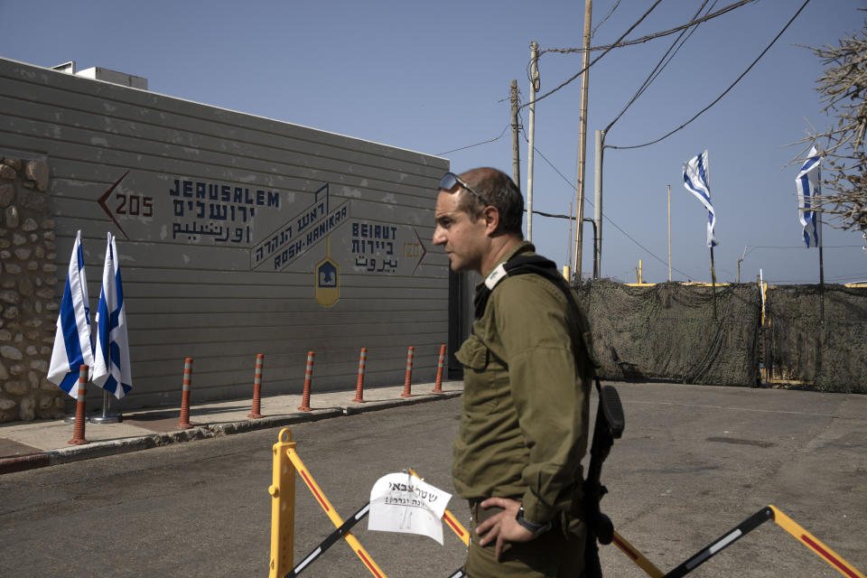 An Israeli army officer stands near a marker at a tourist area overlooking the Mediterranean Sea at the Israeli border with Lebanon in Rosh Hanikra, Israel, Thursday, Oct. 27, 2022. Lebanon signed and delivered its copy of a U.S.-mediated sea border deal with Israel on Thursday to a U.S. mediator, hoping to soon start exploring gas in its southern maritime blocs to bring economic stability to the crisis-ridden country. (AP Photo/Maya Alleruzzo)