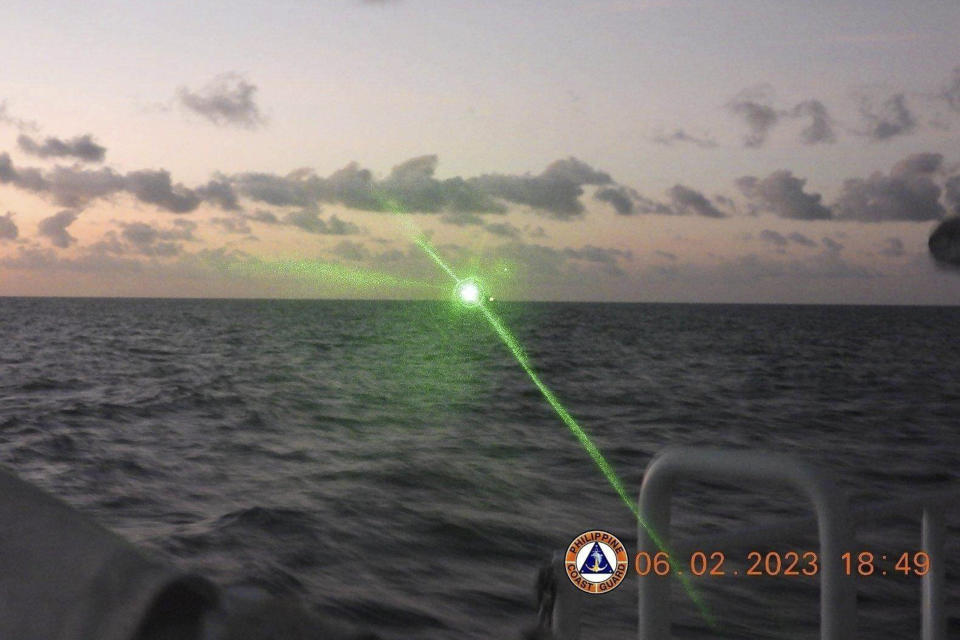 FILE - This photo provided by the Philippine Coast Guard shows a green military-grade laser light from a Chinese coast guard ship in the disputed South China Sea, Feb. 6, 2023. Philippine's President Ferdinand Marcos Jr. said Saturday, Feb. 18, 2023 the Chinese coast guard’s use of a military-grade laser that briefly blinded some crew aboard a Philippine patrol vessel in the disputed South China Sea was not enough for him to invoke a mutual defense treaty with the United States but added he told China that such aggression should stop. (Philippine Coast Guard via AP, File)