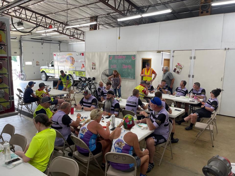 RAGBRAI route inspection riders pause in Quimby to sample the town's specialty: watermelon.