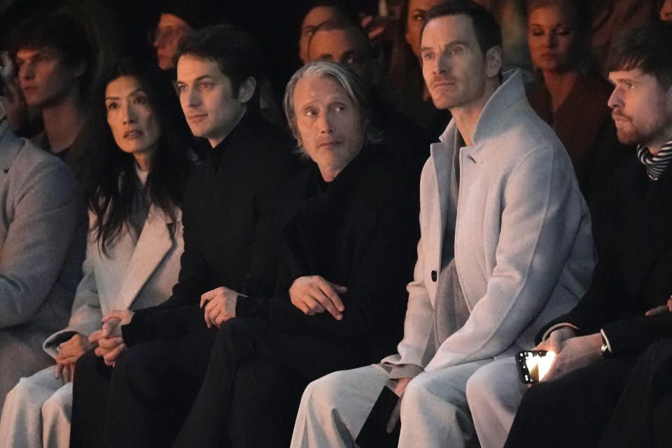 Mads Mikkelsen, centre left, and Michael Fassbender, centre right, attend the men's Zegna Fall-Winter 2024-2025 collection, that was presented in Milan, Italy, Monday, Jan. 15, 2024. (AP Photo/Luca Bruno).