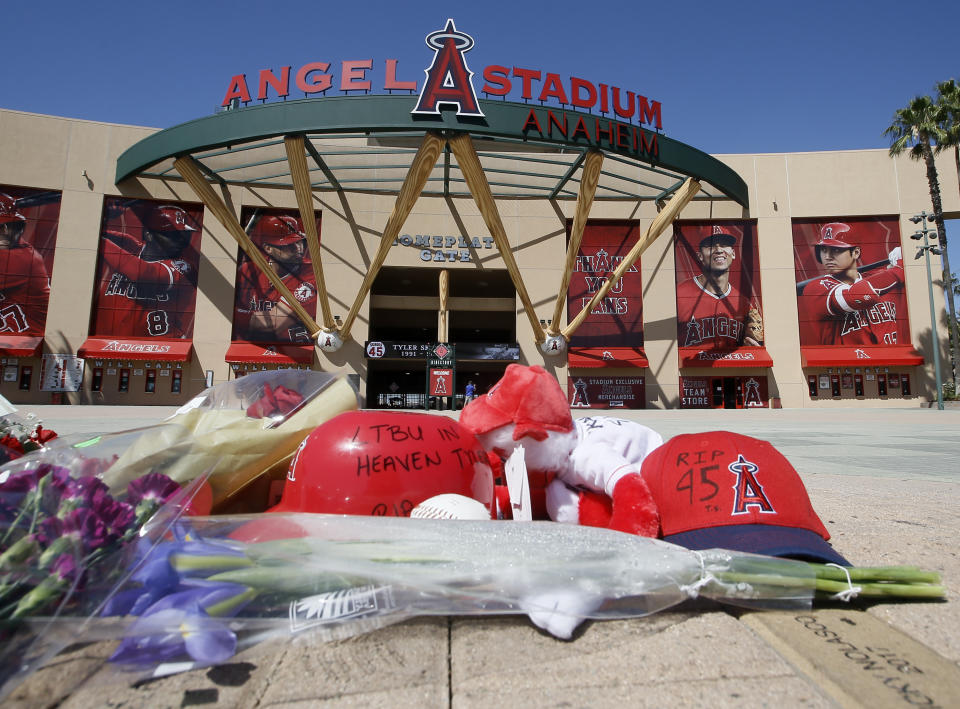 A makeshift memorial is set up in front of Angels Stadium in Anaheim, Calif., for pitcher Tyler Skaggs who died Monday at the age of 27, in Texas, stunning Major League Baseball and leading to the postponement of the team's game against the Texas Rangers Monday, July 1, 2019. (AP Photo/Alex Gallardo)