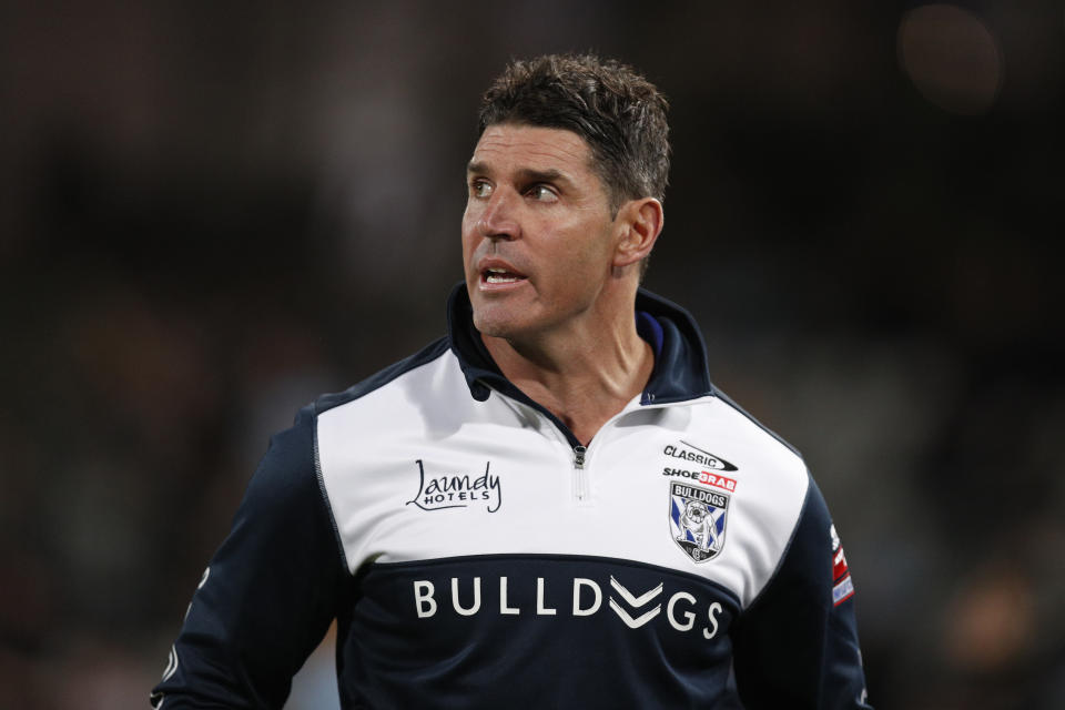 Pictured here, Bulldog coach Trent Barrett watches on during an NRL game in 2021.