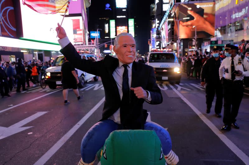 People celebrate after media announced that Democratic U.S. presidential nominee Joe Biden has won the 2020 U.S. presidential election on Times Square in New York City
