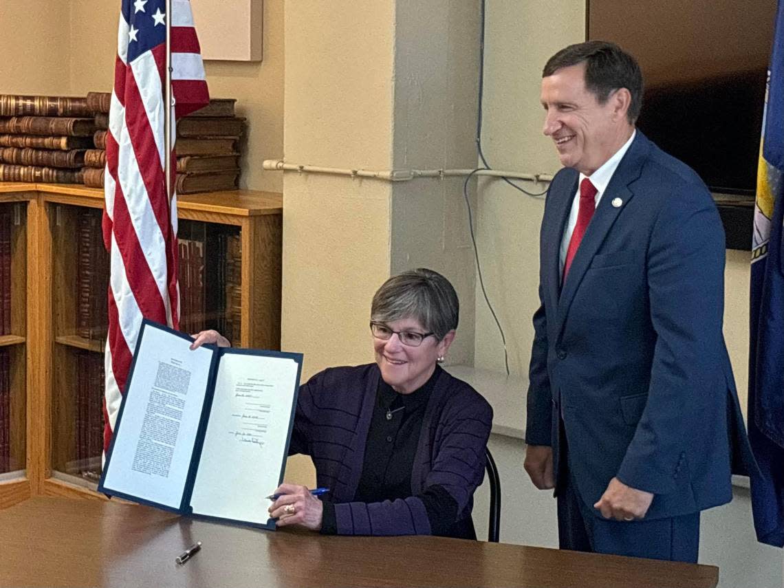 Kansas Gov. Laura Kelly during a ceremonial bill signing of a tax cuts package with Sen. Dennis Pyle. Kelly indicated future property tax cuts may depend on revenue forecasts.