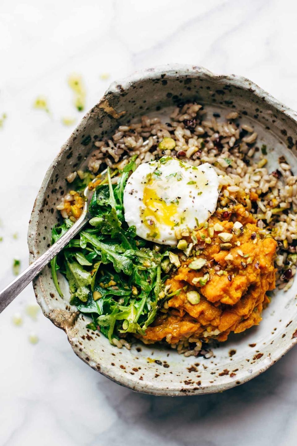 a grain bowl containing veggies and eggs