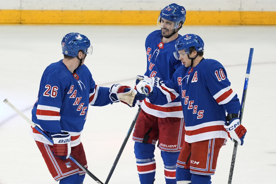 New York Rangers' Chris Kreider (20) celebrates with Jimmy Vesey (26) and Artemi Panarin (10) after scoring an empty-net goal against the Columbus Blue Jackets during the third period of an NHL hockey game Wednesday, Feb. 28, 2024, in New York. The Rangers won 4-1. (AP Photo/Frank Franklin II)