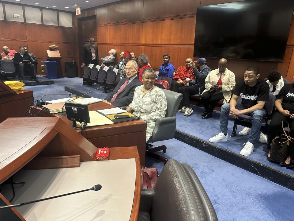 Connecticut Chief Public Defender Tashun Bowden-Lewis chats with supporters before a hearing at the Legislative Office Building in Hartford, Conn. on April 16, 2024, on whether she should keep her job amid allegations of misconduct. She appeared with her attorney Thomas Bucci. (Associated Press/Susan Haigh)