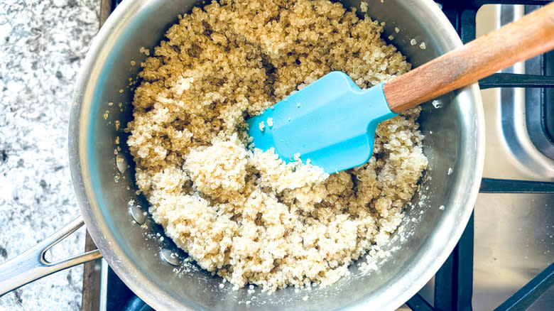 quinoa with blue rubber spatula