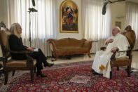 Pope Francis, right, speaks during an interview with The Associated Press at The Vatican, Tuesday, Jan. 24, 2023. Pope Francis said there's a risk that what could be a trailblazing reform process in the German church could become "ideological." In the background a replica of German baroque painter Johann Georg Melchior Schmidtner's oil on canvas, "Mary untier of knots". (AP Photo/Andrew Medichini)