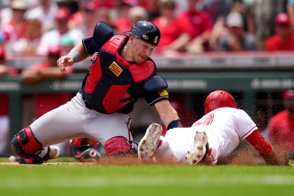 Atlanta Braves catcher Sean Murphy (12) tags out Cincinnati Reds center fielder TJ Friedl at home plate in the first inning during a game this season. Murphy was part of the three-team trade that brought William Contreras and Joel Payamps to Milwaukee.