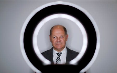 FILE PHOTO: German Finance Minister Olaf Scholz poses for a portrait during an interview with Reuters in his ministry in Berlin