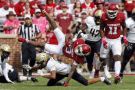 Oklahoma wide receiver Jalil Farooq (3) is tripped up by Central Florida defensive back Demari Henderson on a kickoff return in the first half of an NCAA college football game, Saturday, Oct. 21, 2023, in Norman, Okla. (AP Photo/Nate Billings)