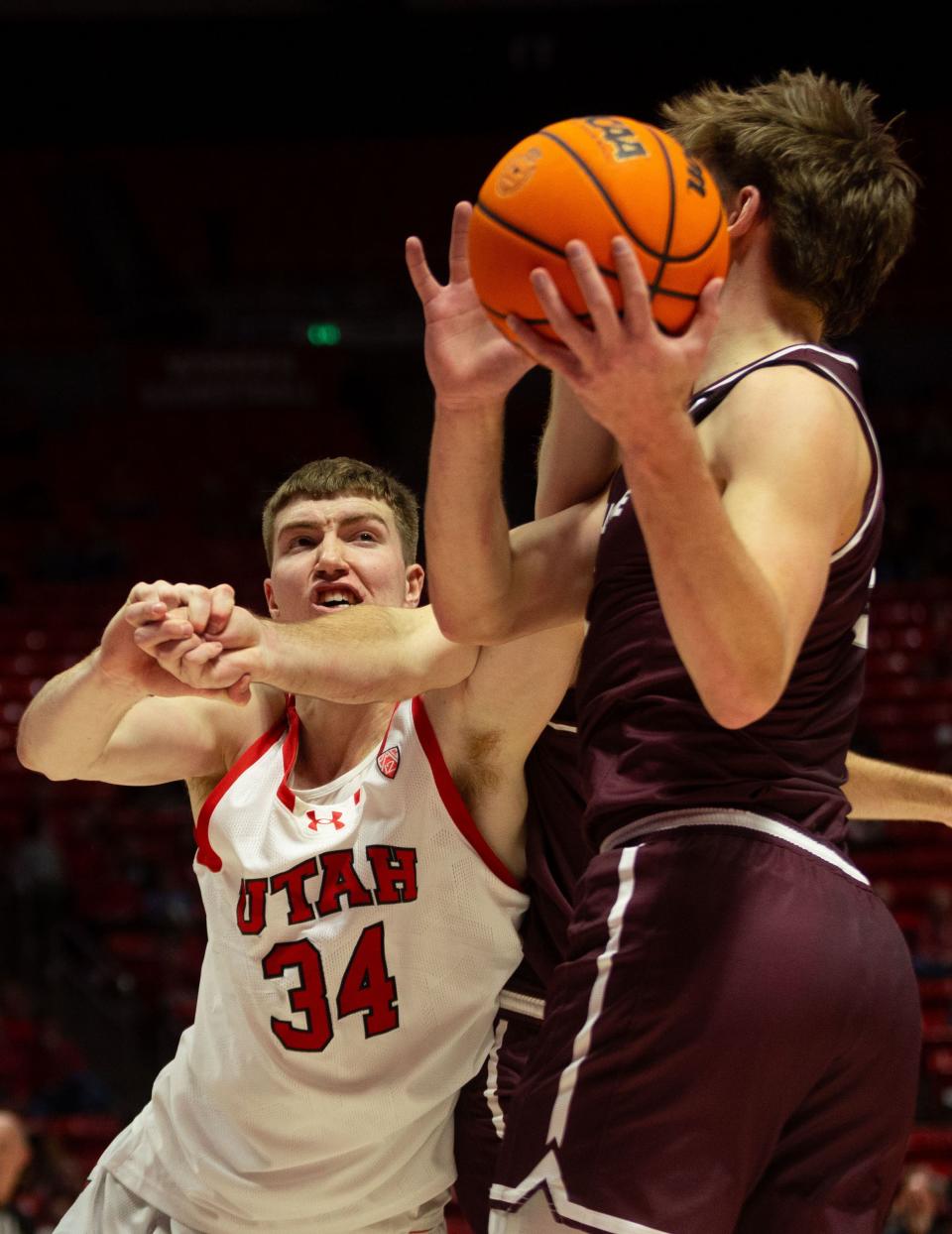 Utah Utes center Lawson Lovering (34) and Bellarmine Knights guard Peter Suder (5) struggle for possession of the ball during the men’s college basketball game between the University of Utah and Bellarmine University at the Jon M. Huntsman Center in Salt Lake City on Wednesday, Dec. 20, 2023. | Megan Nielsen, Deseret News
