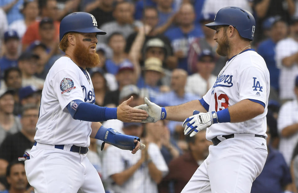 Los Angeles Dodgers' Justin Turner,left, congratulates Max Muncy after he hit a two-run home run against New York Mets starting pitcher Zack Wheeler during the fourth inning of a baseball game Wednesday, Sept. 5, 2018, in Los Angeles. (AP Photo/John McCoy)