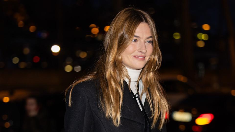 Camille Charriere wears black shorts, net tights, black jacket, bag outside Patou during the Haute Couture Spring/Summer 2024 