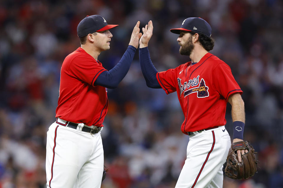 ATLANTA, GA - SEPTEMBER 30: Austin Riley #27 of the Atlanta Braves  reacts with teammate Dansby Swanson #7 at the conclusion of their team's 5-2 victory over the New York Mets at Truist Park on September 30, 2022 in Atlanta, Georgia. (Photo by Todd Kirkland/Getty Images)