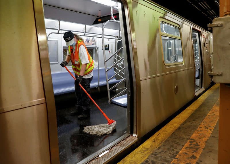 An MTA worker cleans a subway car during the morning commute, as phase one of reopening after lockdown begins, during the outbreak of the coronavirus disease (COVID-19) in New York